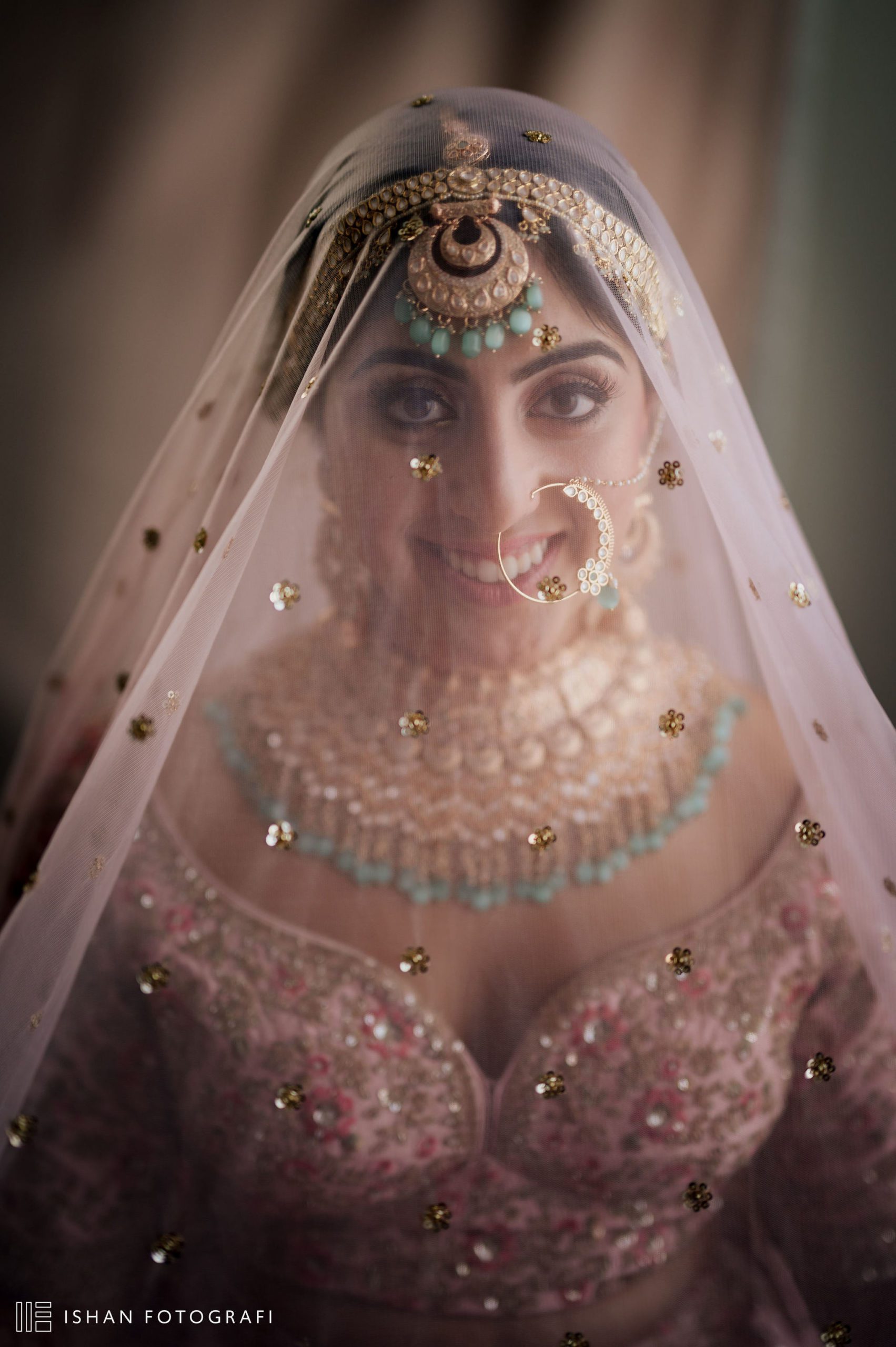 Radiant Indian bride in NJ prepares for the wedding ceremony with help from loved ones.