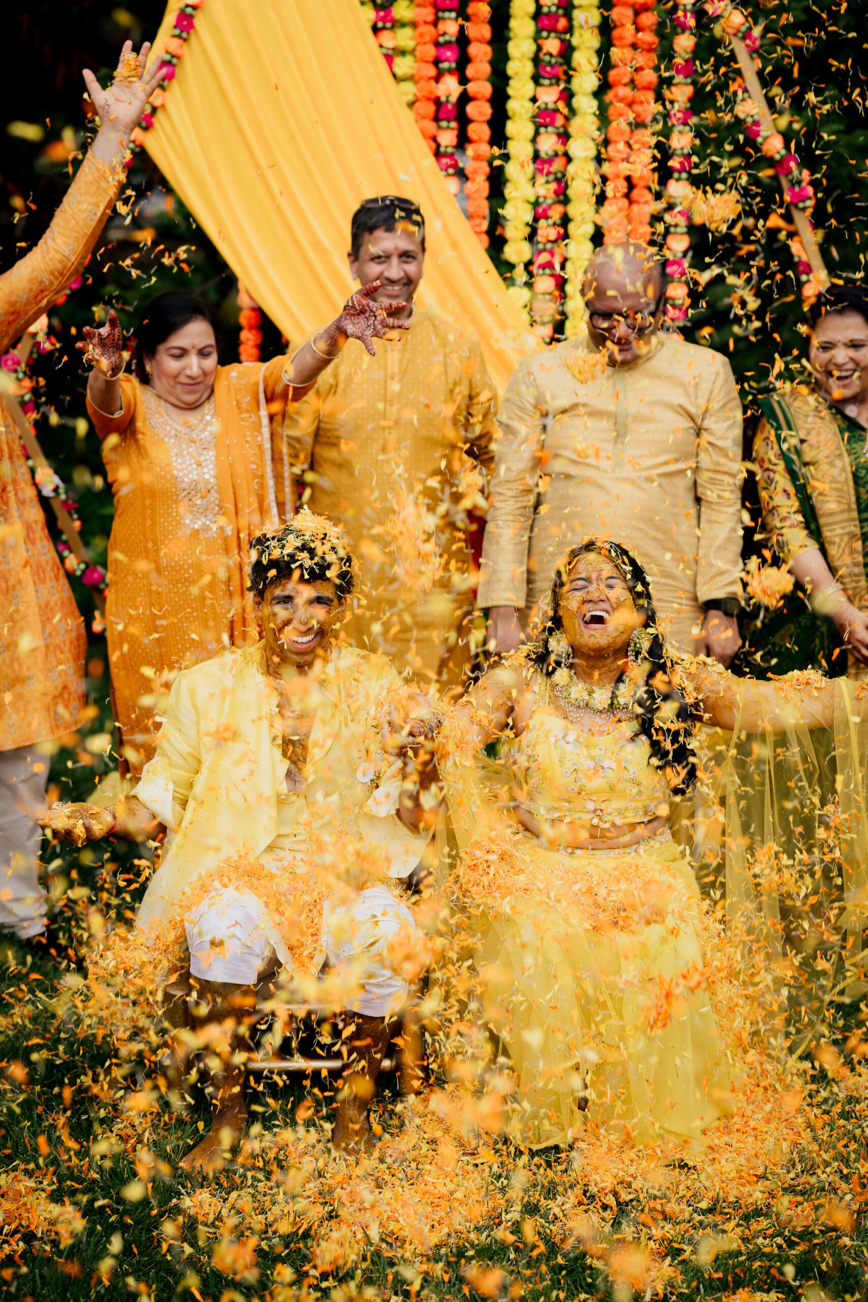 Husband and wife photographers capturing a raw, emotional moment at a vibrant Indian wedding in NJ and NY.